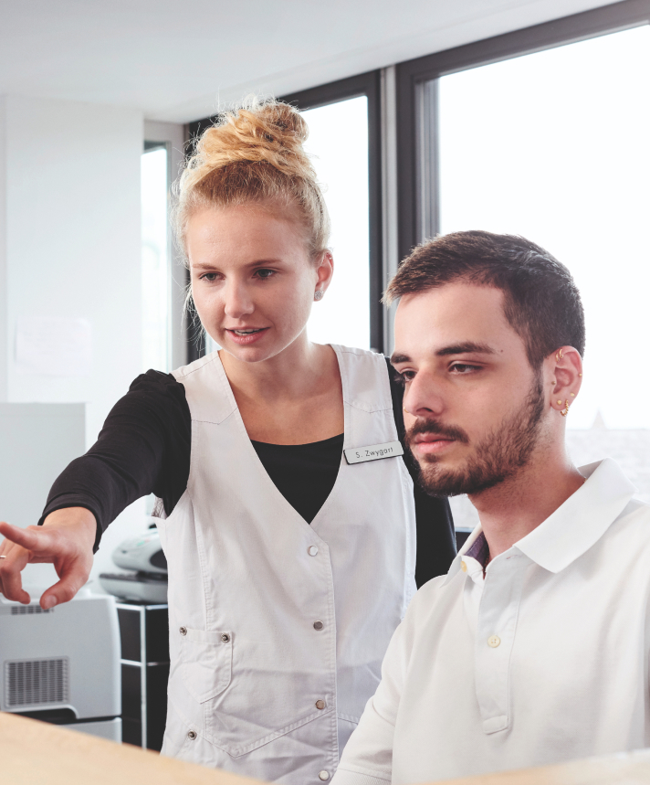 two people looking at a screen